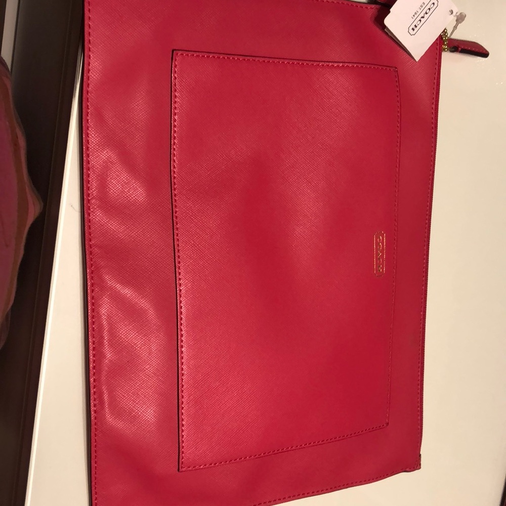 A Pink coach clutch or iPad holder